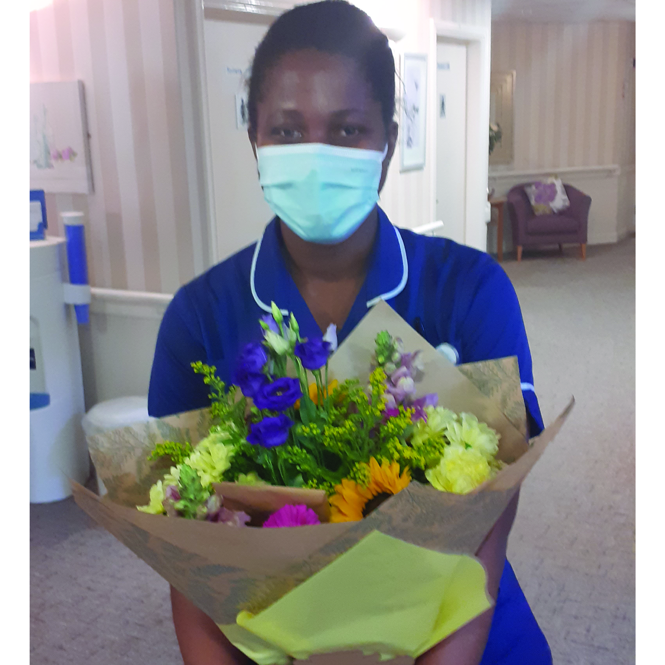 Nurse passing her OSCE exam gifted with flowers and presents