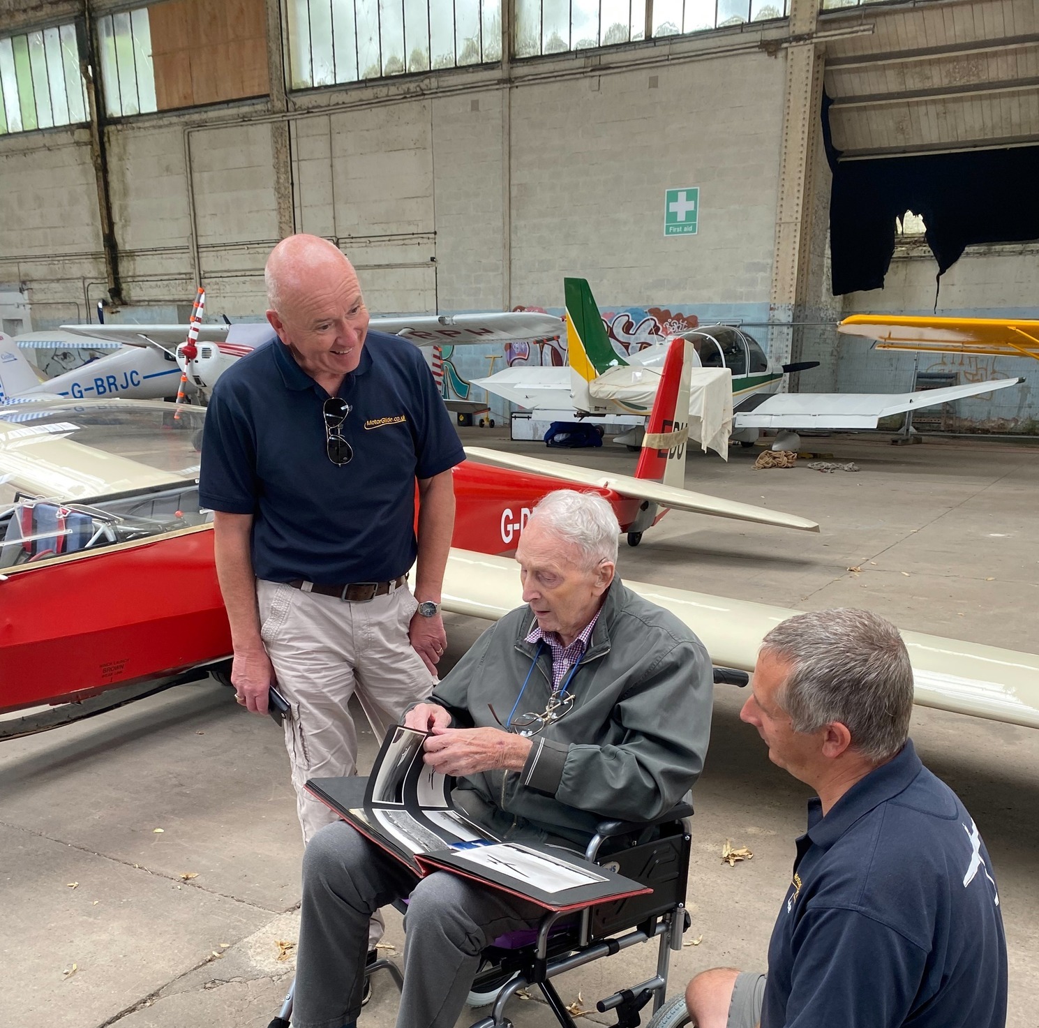 Peter showing his book of images of gliders he has flown