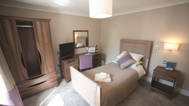Hope Green bedroom with dressing table, TV and wardrobe