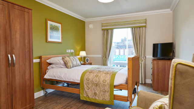 Appletree Court bedroom with armchair and wardrobe