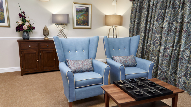 Appletree Court lounge with armchairs and games