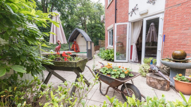 Belmont House garden with seating area and plants