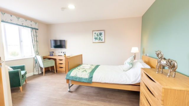 Belmont House bedroom with dressing table and TV