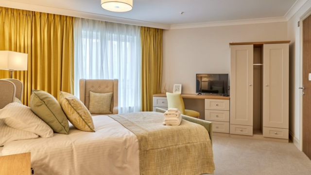Lace Hill bedroom with large window and TV