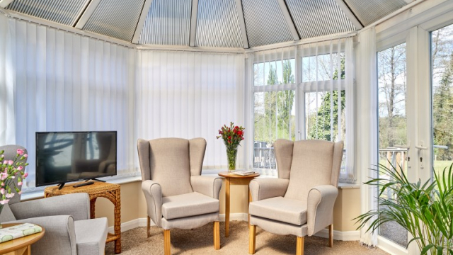 Bridge House conservatory with seating and TV