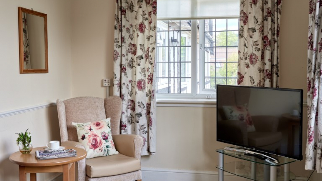 Furze Hill corner of the bedroom with TV and armchair