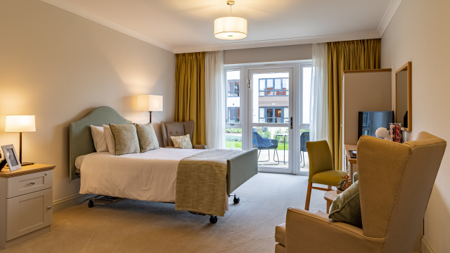 Chartwell Manor bedroom with patio doors and outdoor seating 