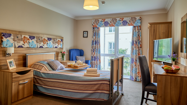 Brunel House bedroom with large window, dressing table and TV