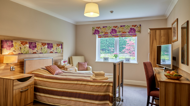 Brunel House bedroom with window, dressing table and TV