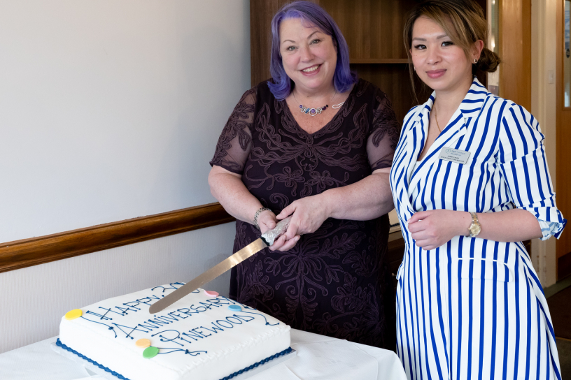 Pinewood's managers cutting their birthday cake 